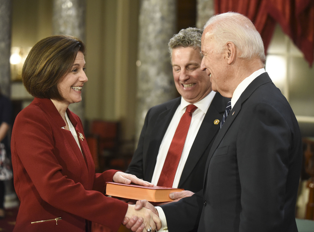 El vicepresidente Joe Biden, a la derecha, estrecha la mano a la senadora Catherine Cortez Masto (Demócrata por Nevada), mientras su esposo, Paul Masto sostiene una biblia, durante un ensayo para ...