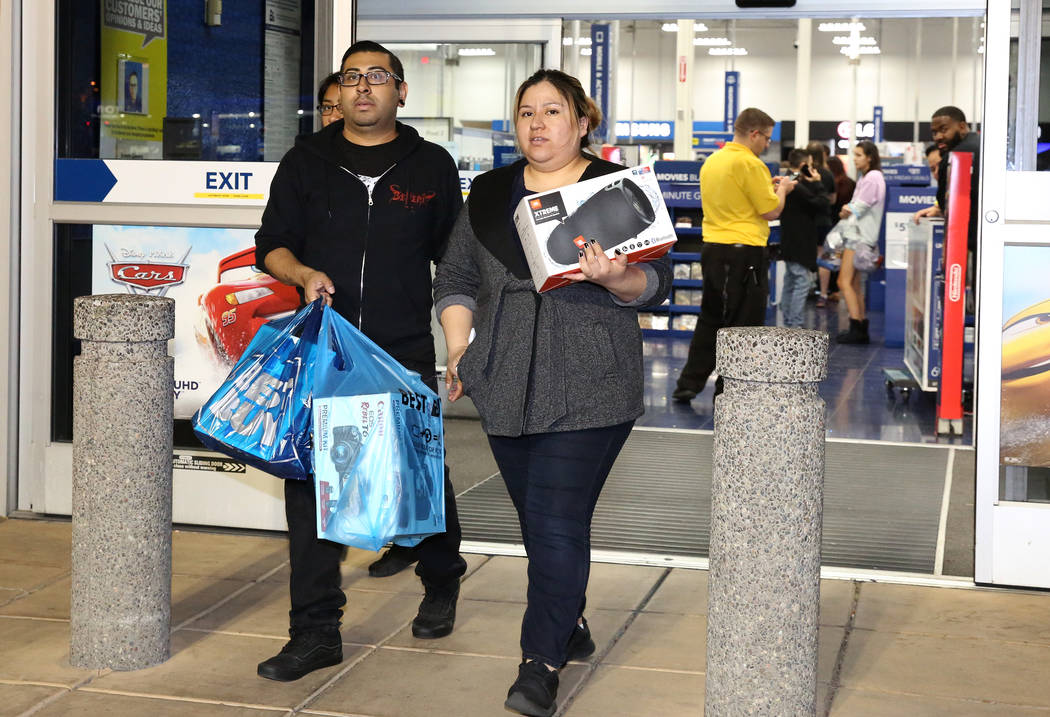 Jorge Santiago y su esposa, Lesly, salen con sus compras a la 1:04 a.m. después de las compras del Black Friday en Best Buy en Henderson el 24 de noviembre de 2017 en Las Vegas. (Bizuayehu Tesfay ...