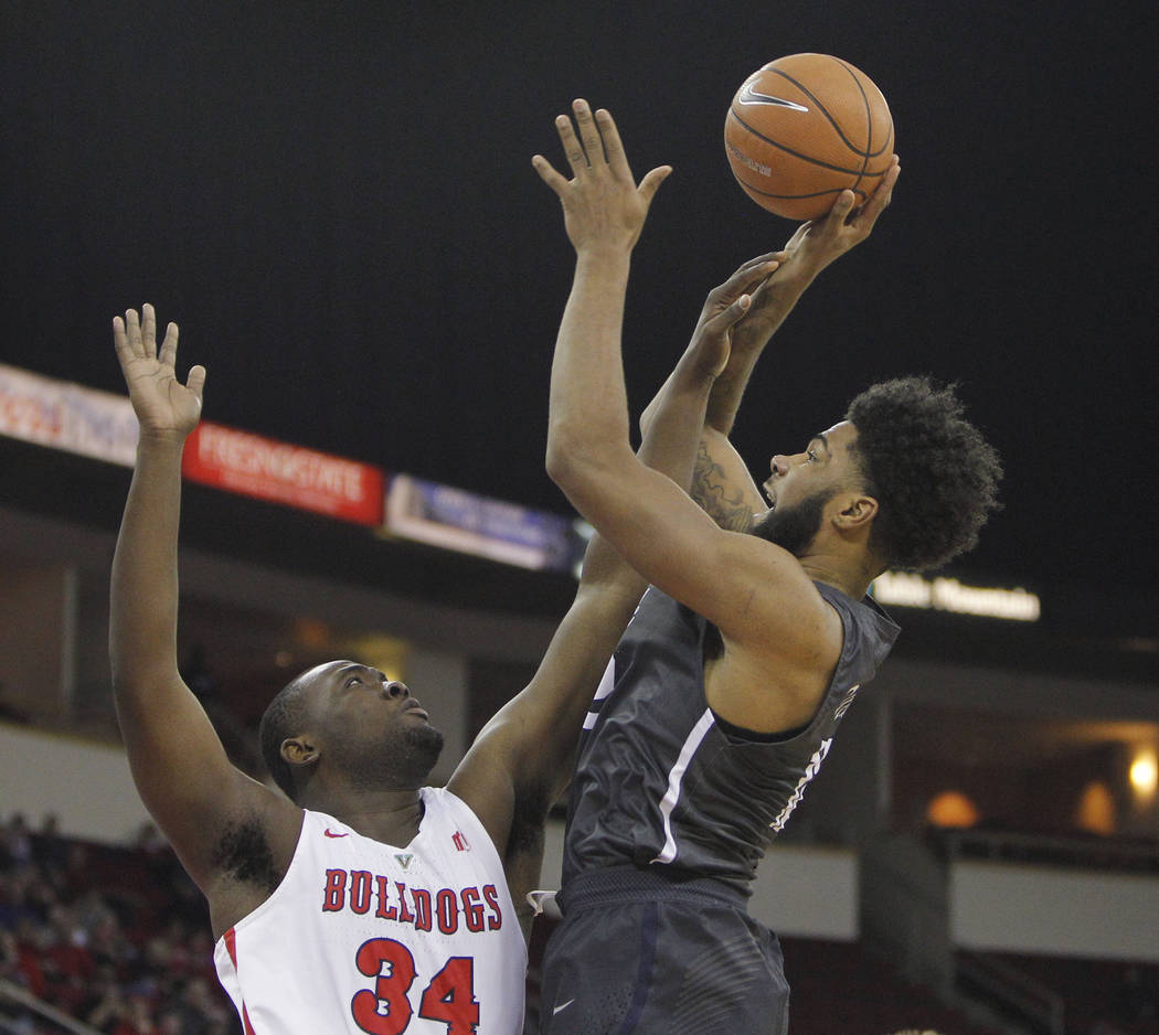 Nevada's Elijah Foster goes up for a shot against Fresno State's Terrell Carter II during the first half of an NCAA college basketball game in Fresno, Calif., Wednesday, Dec. 27, 2017. (AP Photo/G ...