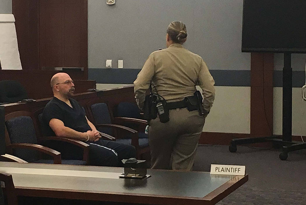 Las Vegas police officer Bret Theil, left, awaits an arraignment on dozens of sexual assault and kidnapping charges on Wednesday, Feb. 14, 2018. (David Ferrara/Las Vegas Review-Journal)
