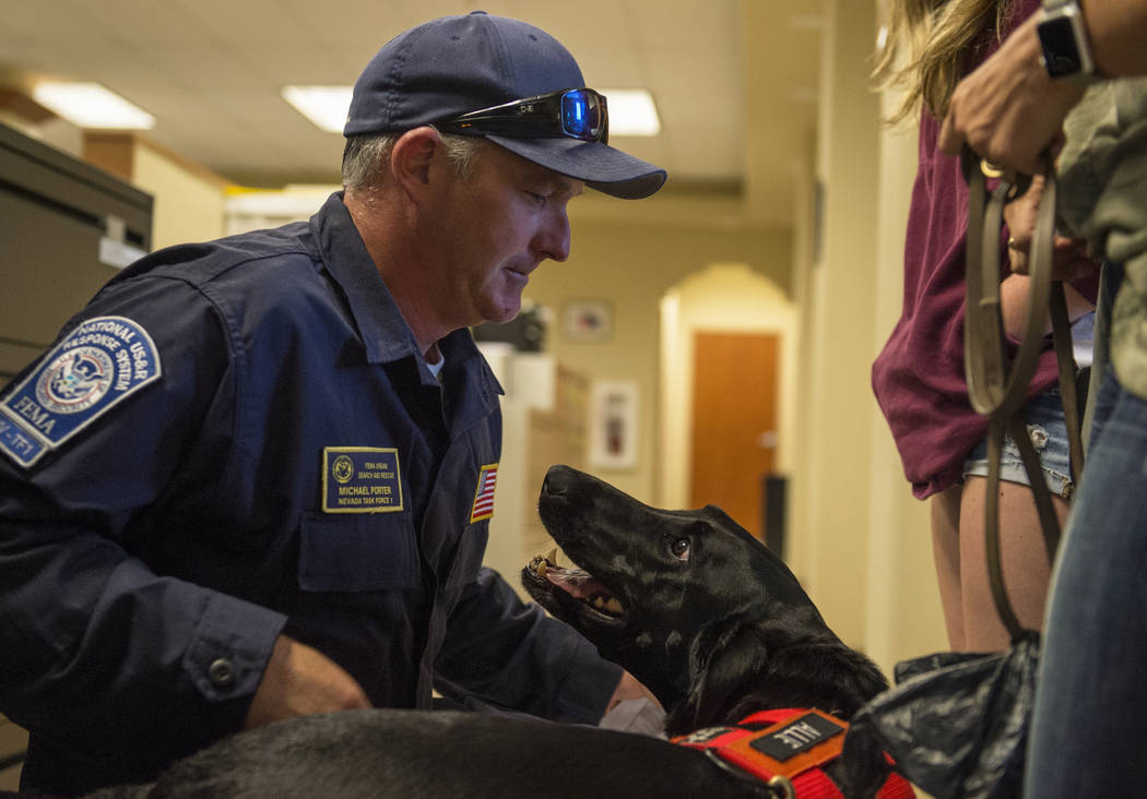 Mike Porter del Departamento de Bomberos de Henderson saluda a su perro, Allie, mientras Nevada Task Force 1 regresa de las áreas afectadas por el huracán Florence en Las Vegas, el lunes 24 de s ...