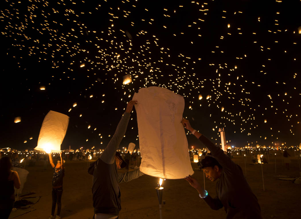 Participants ignite a lantern during the RiSE Lantern Festival held at the Moapa River Indian Reservation on Friday, Oct. 6, 2017. Richard Brian Las Vegas Review-Journal @vegasphotograph