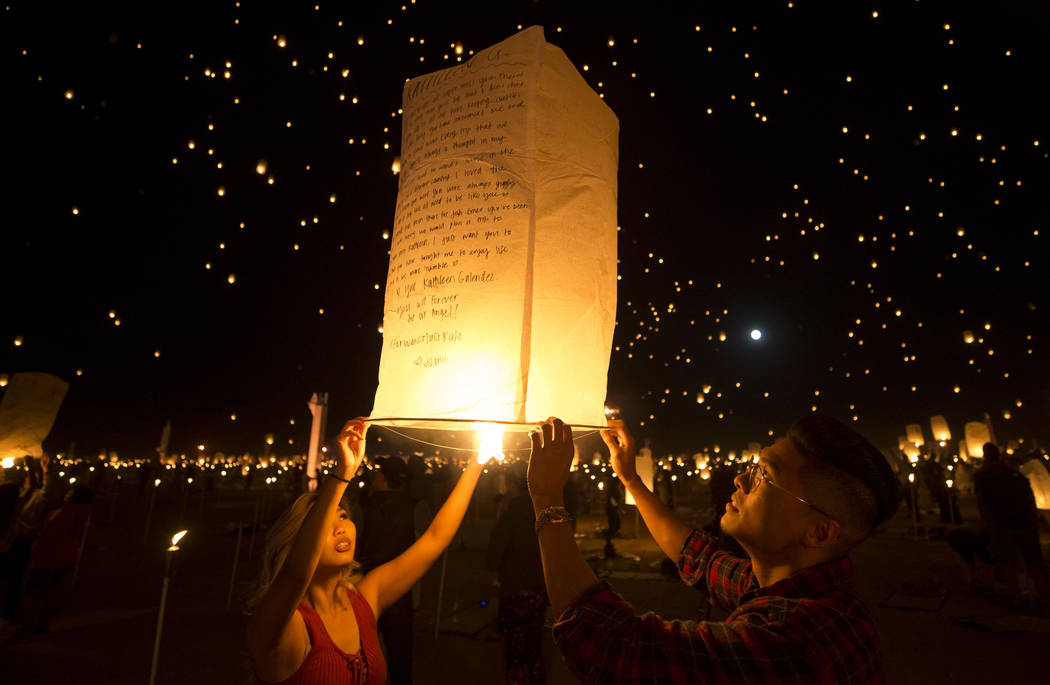 Participants ignite a lantern during the RiSE Lantern Festival held at the Moapa River Indian Reservation on Friday, Oct. 6, 2017. Richard Brian Las Vegas Review-Journal @vegasphotograph