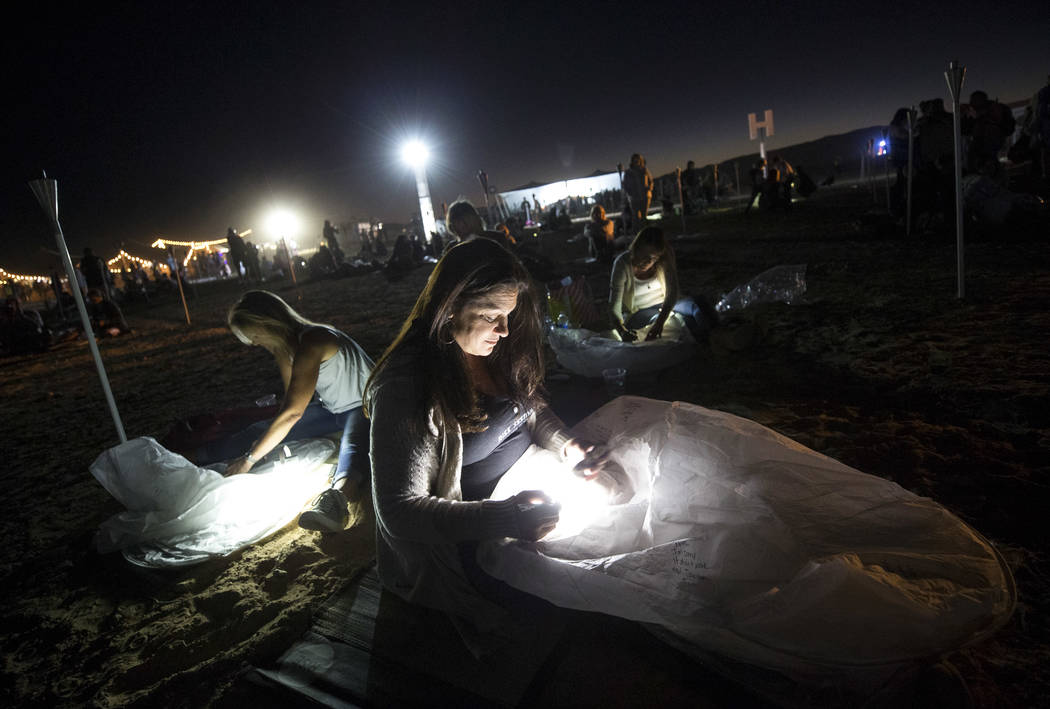 Terri Alzado of Florida writes a message on a lantern during the RiSE Lantern Festival held at the Moapa River Indian Reservation on Friday, Oct. 6, 2017. Richard Brian Las Vegas Review-Journal @v ...