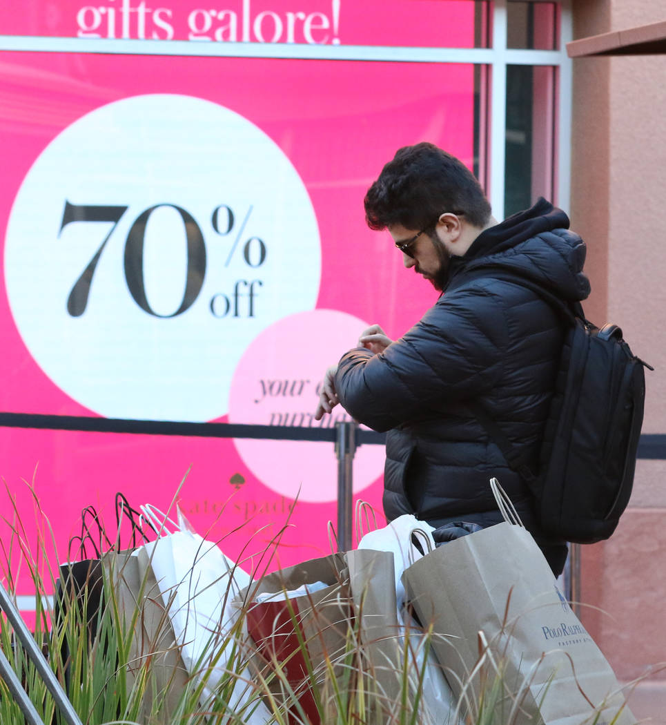 Paulo Soares of Brazil waits for his girlfriend after shopping during Black Friday at the North Premium Outlet Mall on Friday, Nov. 23, 2018. Bizuayehu Tesfaye Las Vegas Review-Journal @bizutesfaye