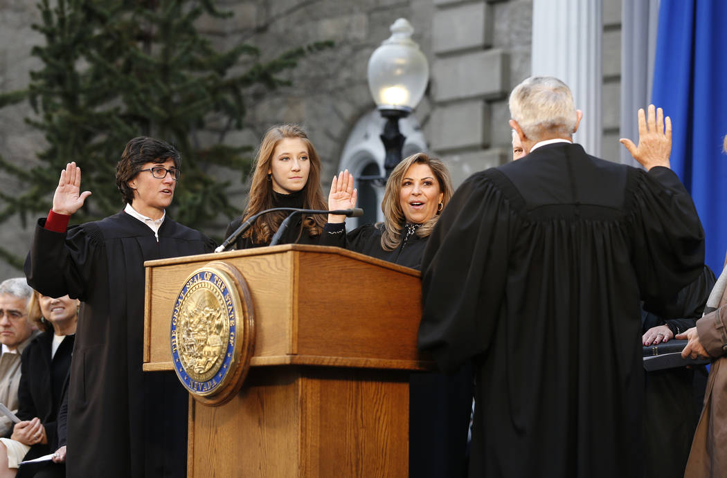 Los jueces de la Corte Suprema de Nevada, Lidia Siglich, a la izquierda, Abbi Silver, centro, y Elissa Cadish, no vistos, prestan juramento ante el Juez Principal de la Corte Suprema James Hardest ...