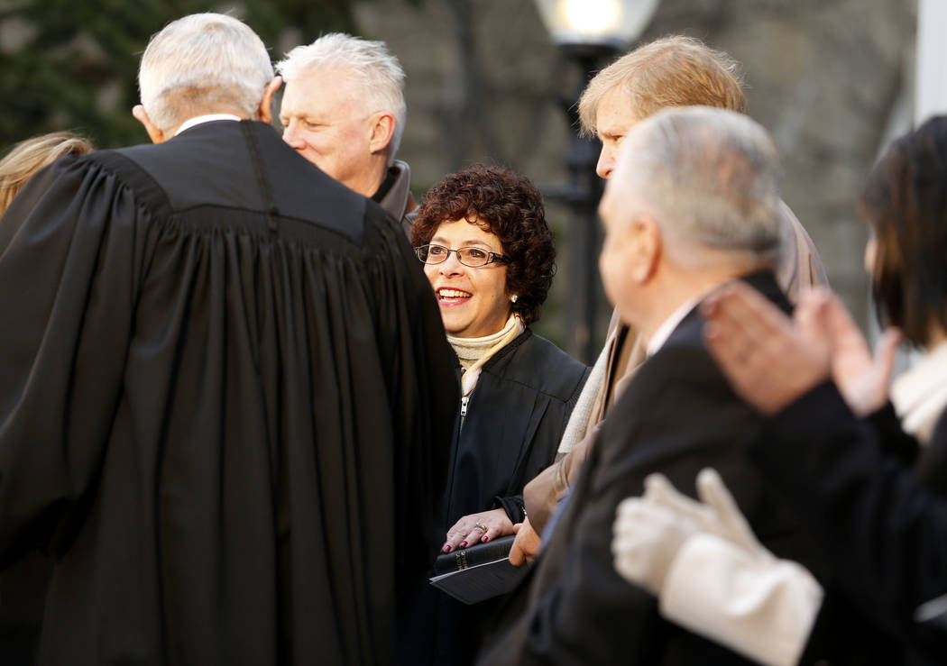 El presidente del Tribunal Supremo de Nevada, James Hardesty, felicita a la jueza Elissa Cadish, centro, después de que prestó juramento durante la inauguración en el Capitolio, en Carson City, ...