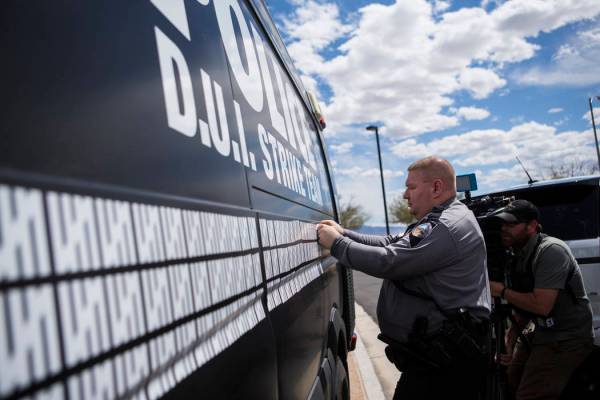 Nevada Highway Patrol trooper Dan Slattery adds a marking to indicate 500 arrests by the DUI St ...