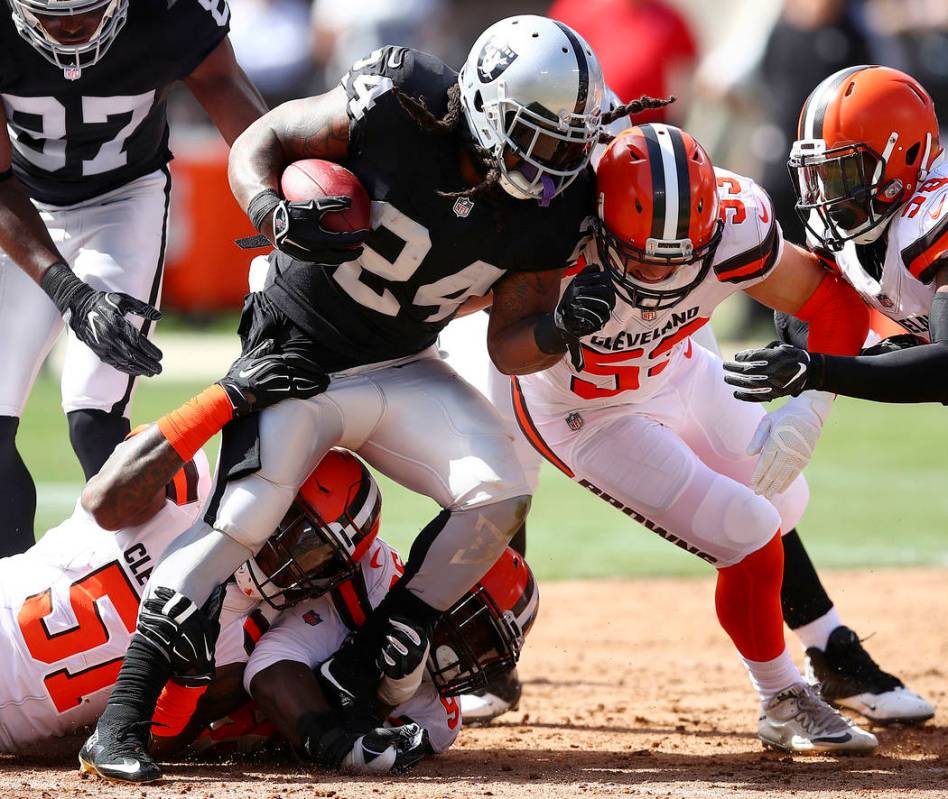 El corredor de los Oakland Raiders, Marshawn Lynch (24), es detenido por los Browns de Clevelan ...