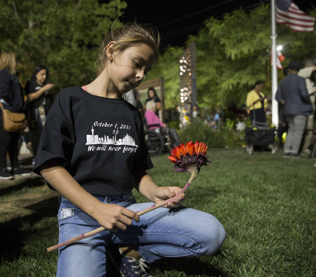 Ella Goldy sostiene un girasol rojo en honor a su madre Samantha Olander, quien sobrevivió al ...