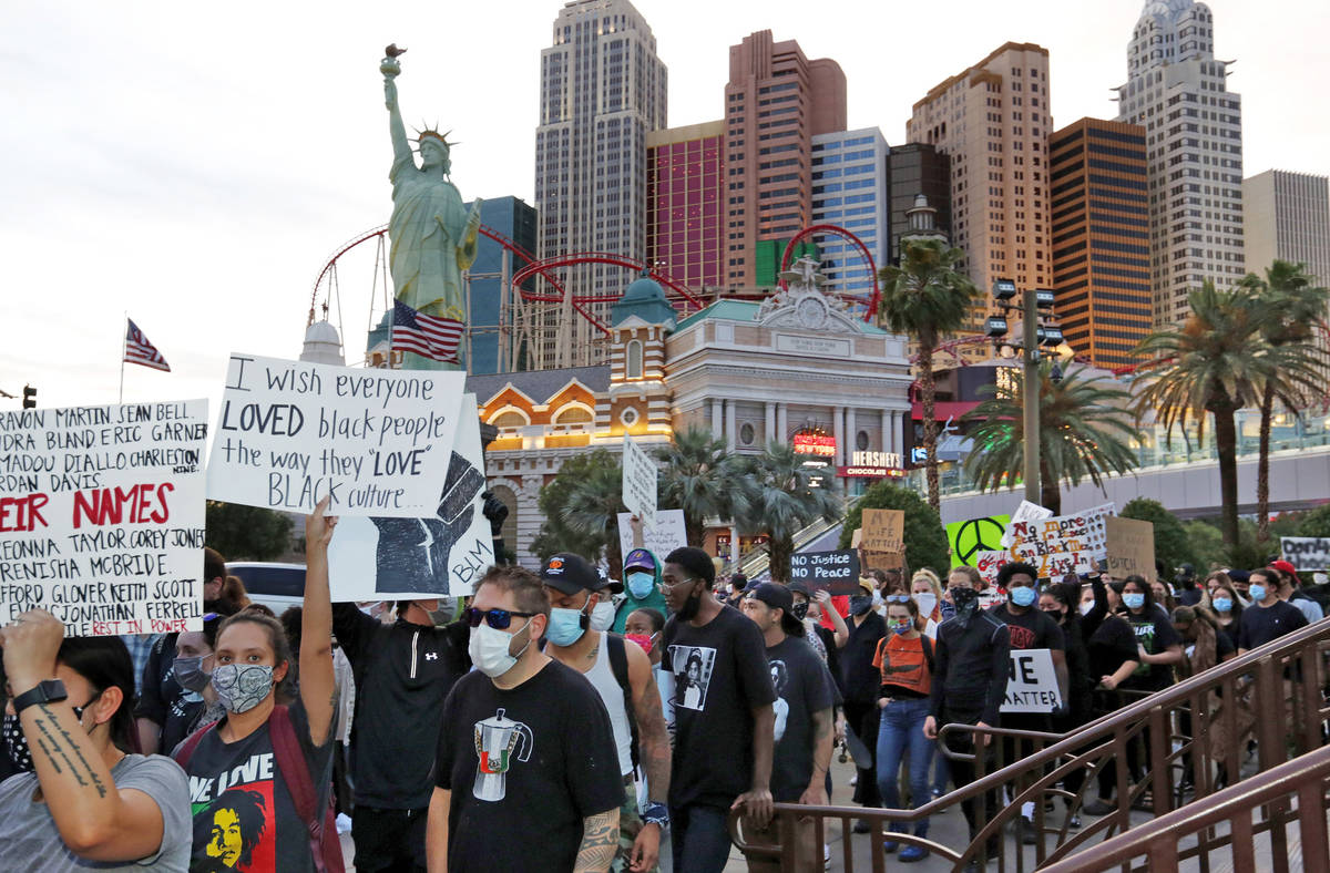 La gente marcha a lo largo del Strip de Las Vegas el domingo, 31 de mayo de 2020, durante una p ...