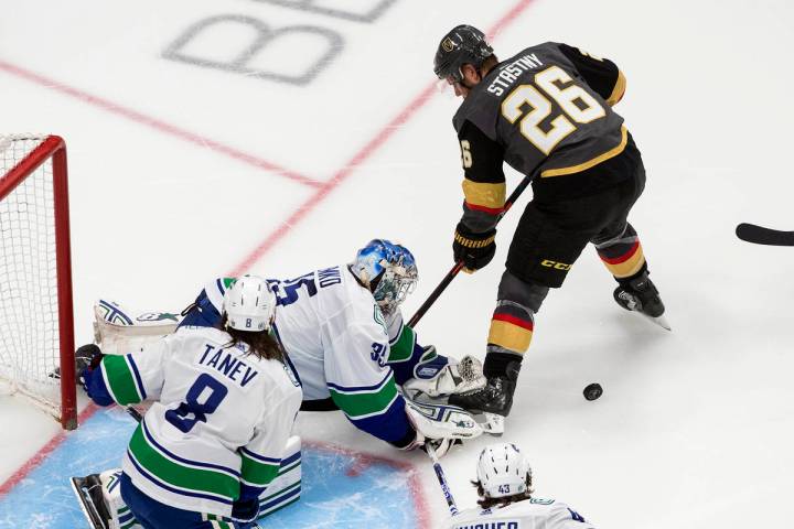 El portero de los Canucks de Vancouver, Thatcher Demko (35), hace una atajada contra Paul Stast ...