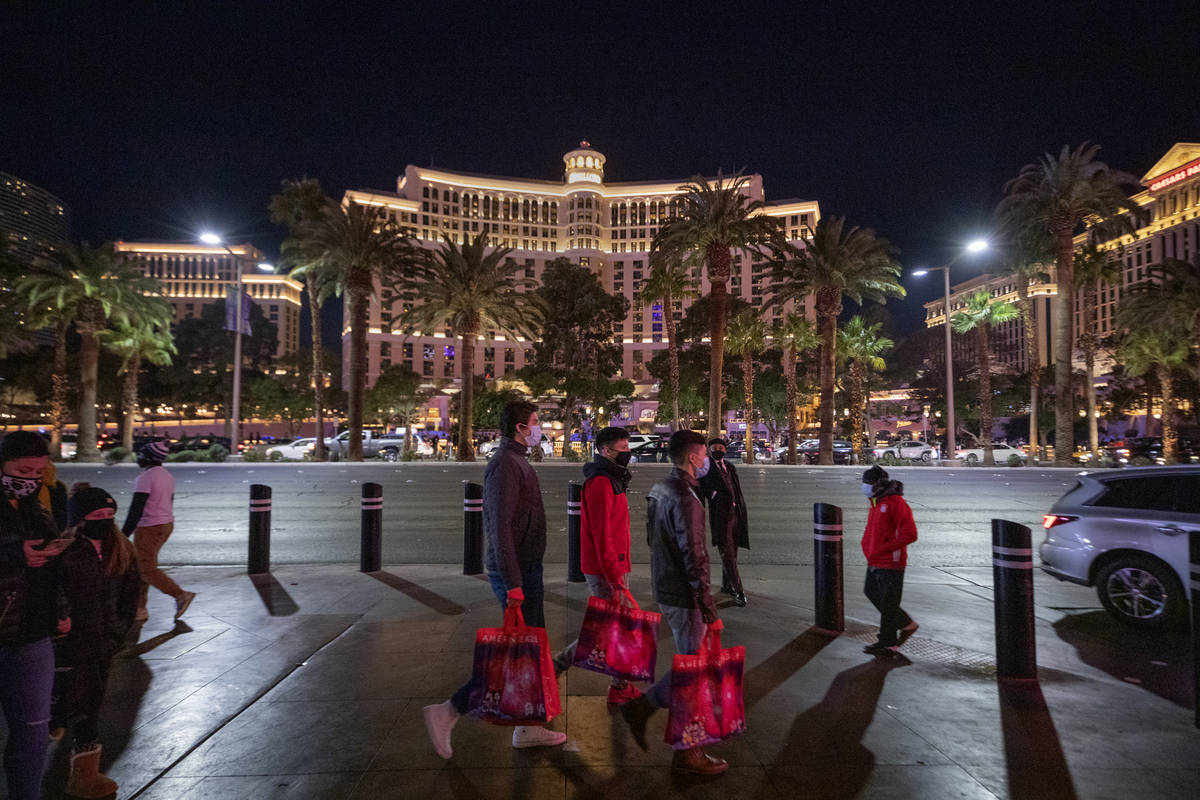 Tourists walk down Las Vegas Blvd., on the Strip, Friday, Nov. 27, 2020, in Las Vegas. (Elizabe ...