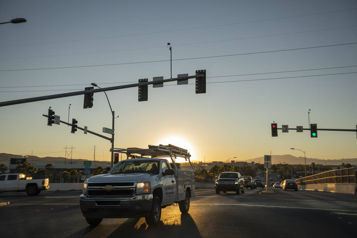 Cars drive across a street to enter the Auto Show Drive onramp to U.S. Highway 95 in Henderson ...