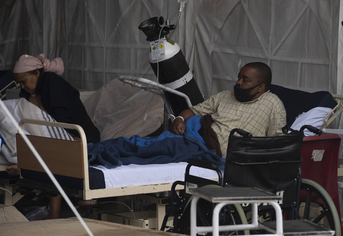 Pacientes esperan para ser atendidos en el estacionamiento exterior del Biko Academic Hospital ...