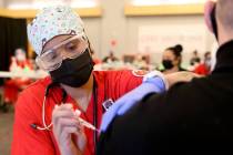 La estudiante de enfermería, Alaysia Robinson, administra una vacuna contra COVID-19 en la Uni ...