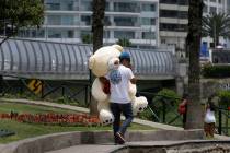 En esta foto de archivo, un hombre lleva un oso de peluche muy grande el día de San Valentín ...