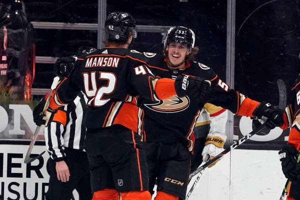 El ala izquierda de los Anaheim Ducks, Max Comtois, a la derecha, celebra con Josh Manson (42) ...