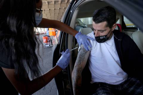 David Lotta, de Las Vegas, recibe su inyección de Destanee Sanders durante una clínica de vac ...