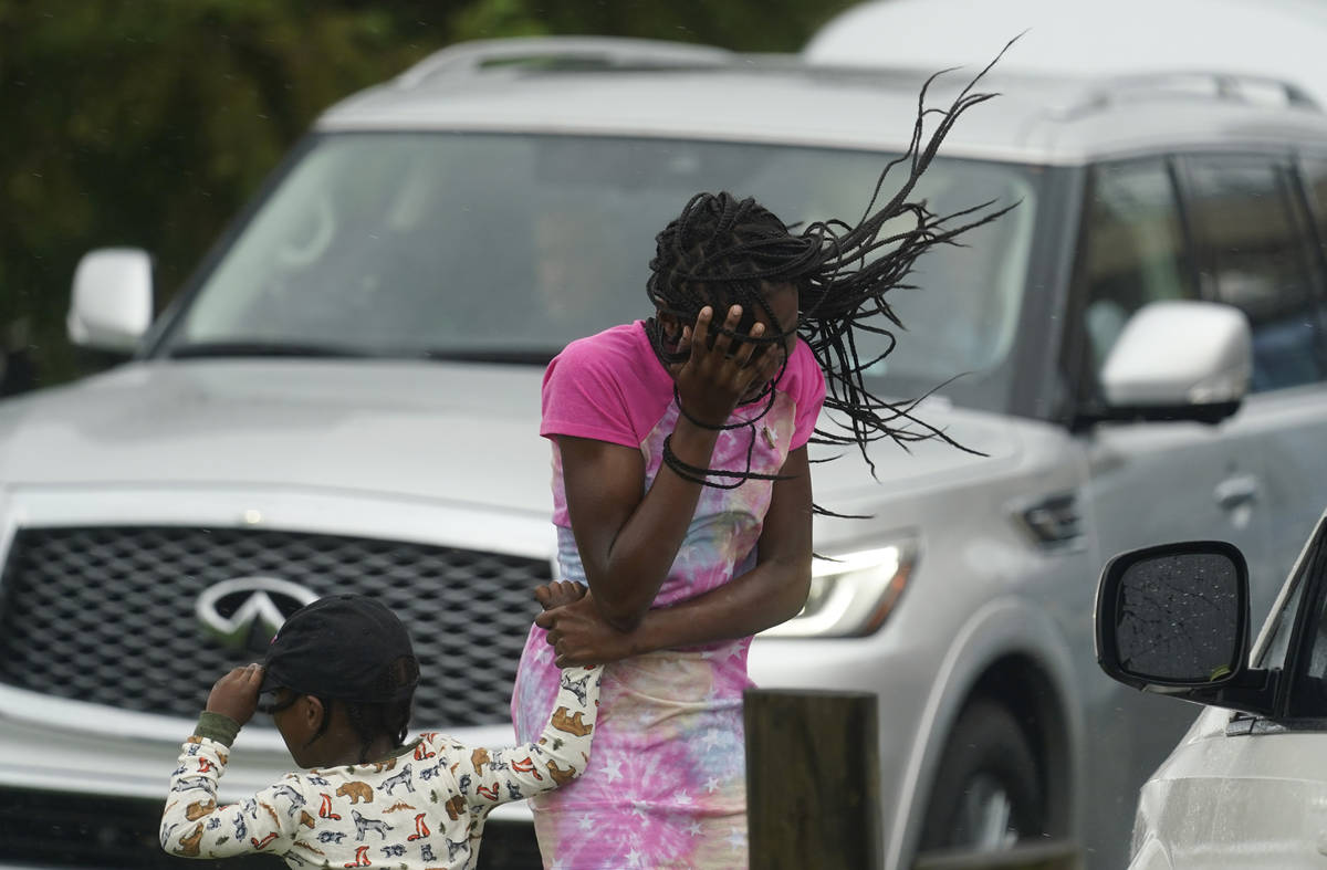 Una niña bloquea su rostro del viento y la lluvia producidos por el huracán Ida, el domingo 2 ...