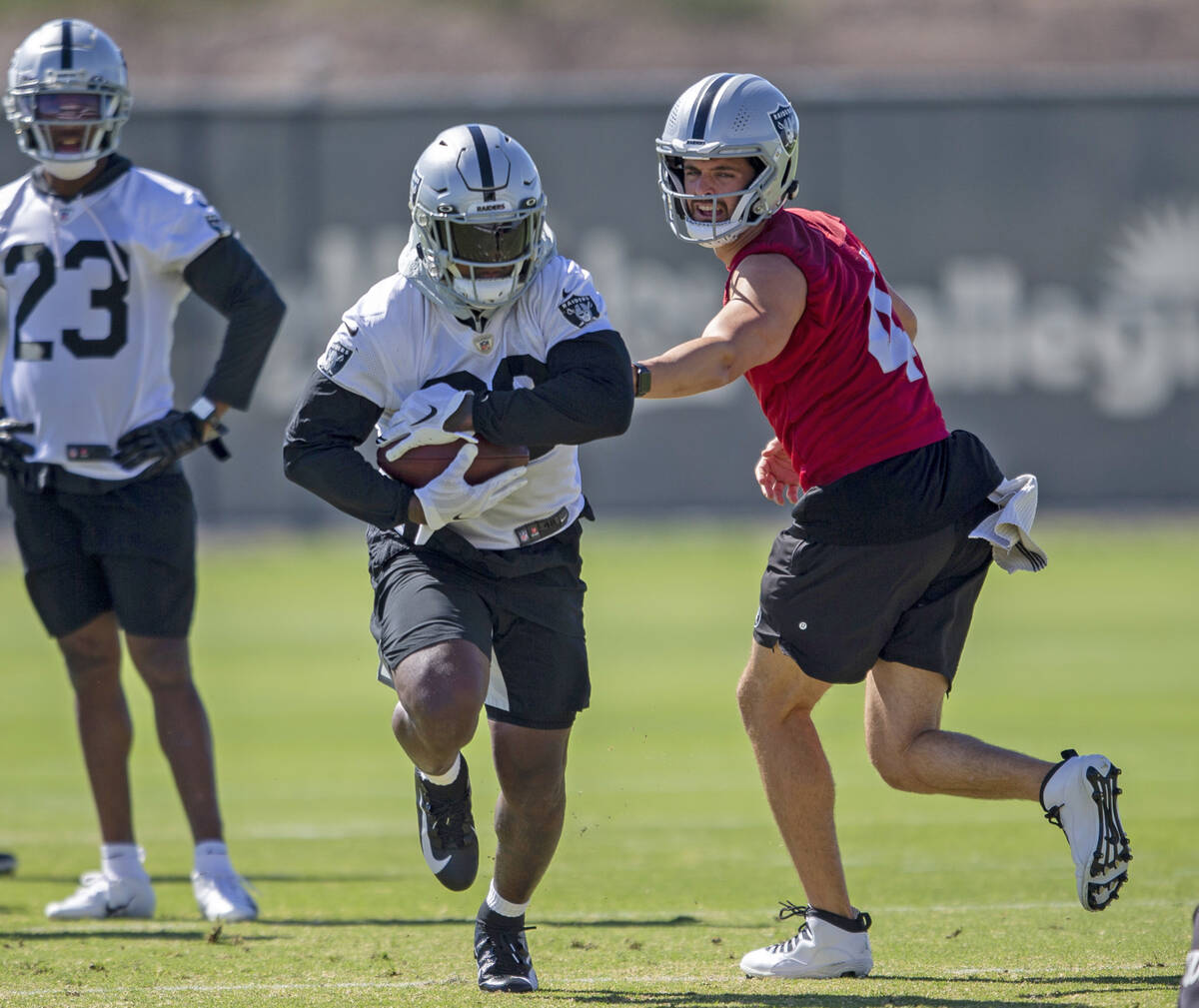 El quarterback de los Raiders, Derek Carr (4), entrega el balón al running back de los Raiders ...