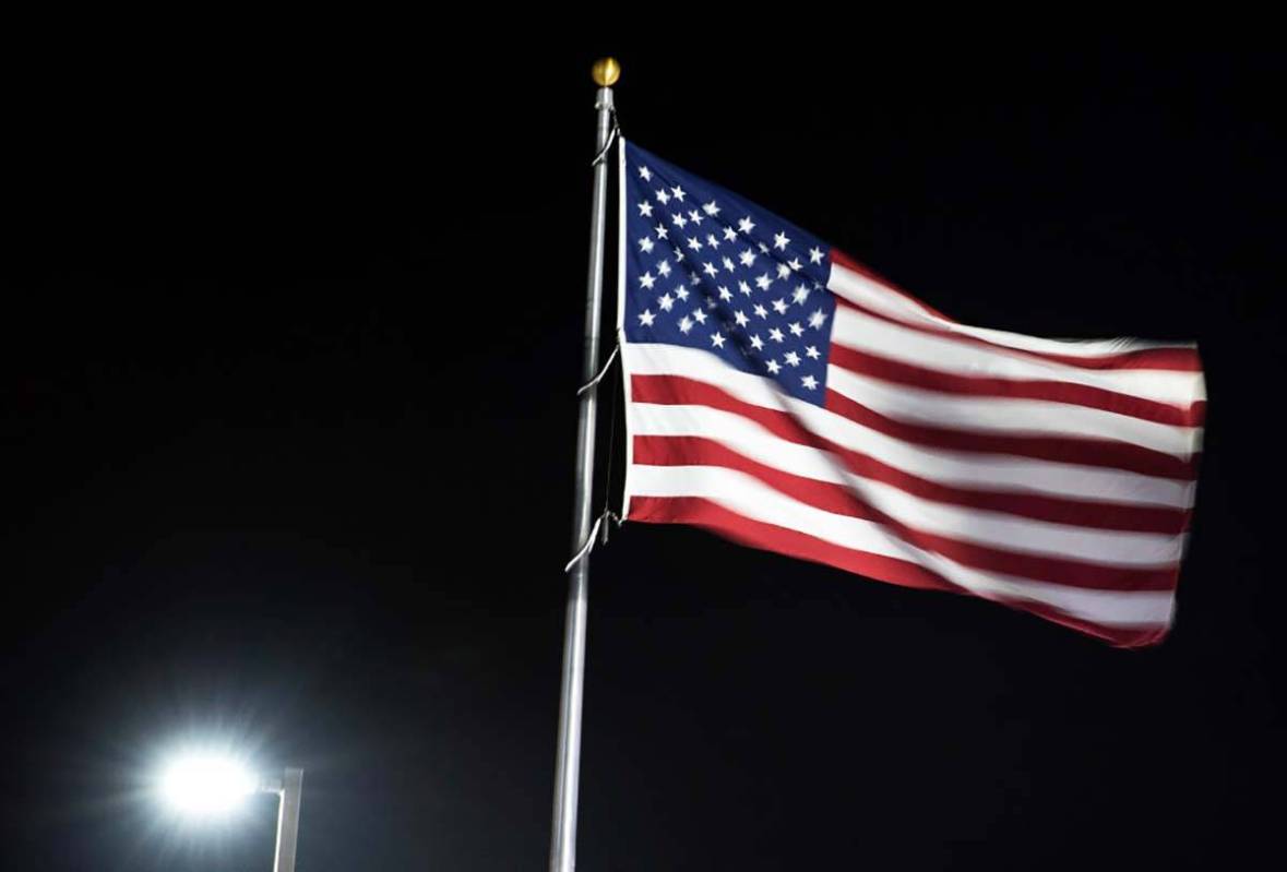 Una gran bandera estadounidense ondea al viento durante una fresca y ventosa mañana de lunes, ...