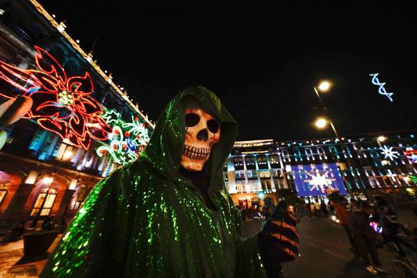 Una persona vestida de La Santa Muerte posa para una foto en la plaza principal de la Ciudad de ...