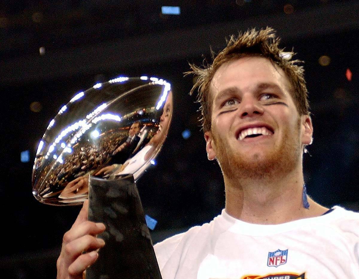 El quaterback de los New England Patriots, Tom Brady, sostiene el Trofeo Vince Lombardi despué ...