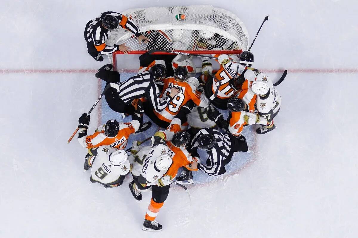 Jugadores de los Philadelphia Flyers y de los Vegas Golden Knights luchan durante el primer per ...