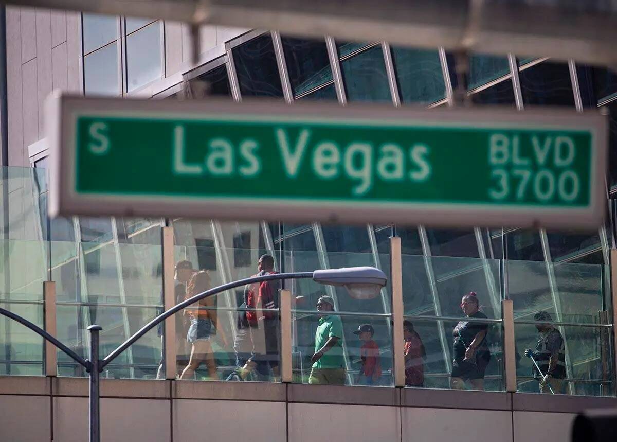 Peatones cruzan un puente a lo largo del Strip de Las Vegas el miércoles 6 de abril de 2022, e ...