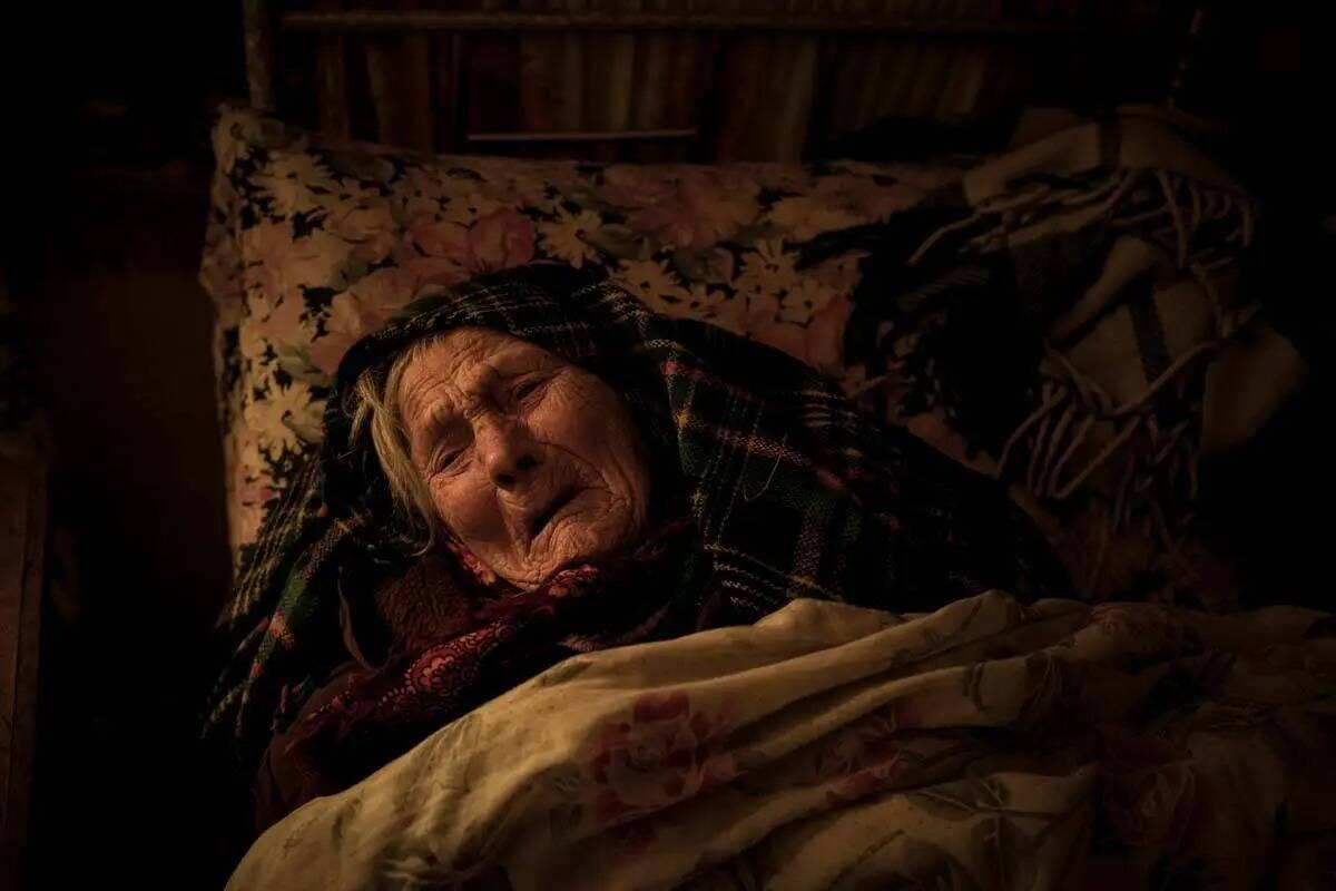 Motria Oleksiienko, de 99 años, traumatizada por la ocupación rusa, yace en su cama en una ha ...