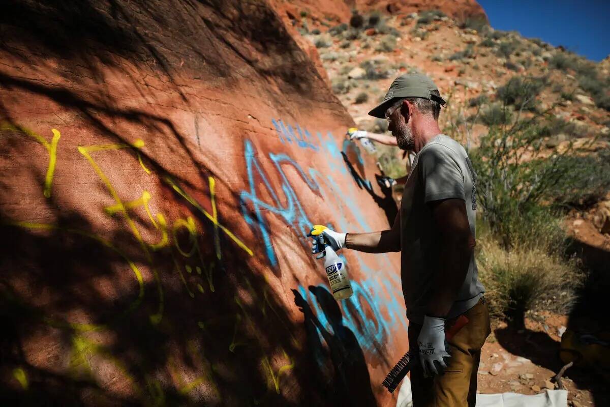 El voluntario Rick Momsen trabaja para eliminar grafitis en el sendero de Ash Springs en Red Ro ...