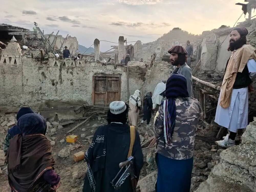 En esta foto publicada por la agencia de noticias estatal Bakhtar, afganos observan la destrucc ...