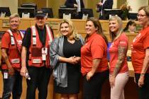 Miembros de la Cruz Roja posan para un retrato junto a la concejal de Las Vegas, Michele Fiore, ...