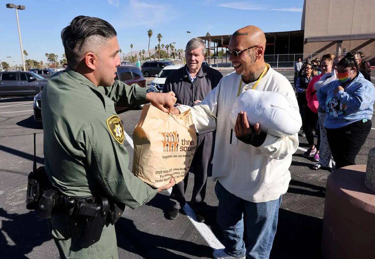 El oficial de policía de Las Vegas Alfredo Calata, le da una comida de Thanksgiving a Charles ...