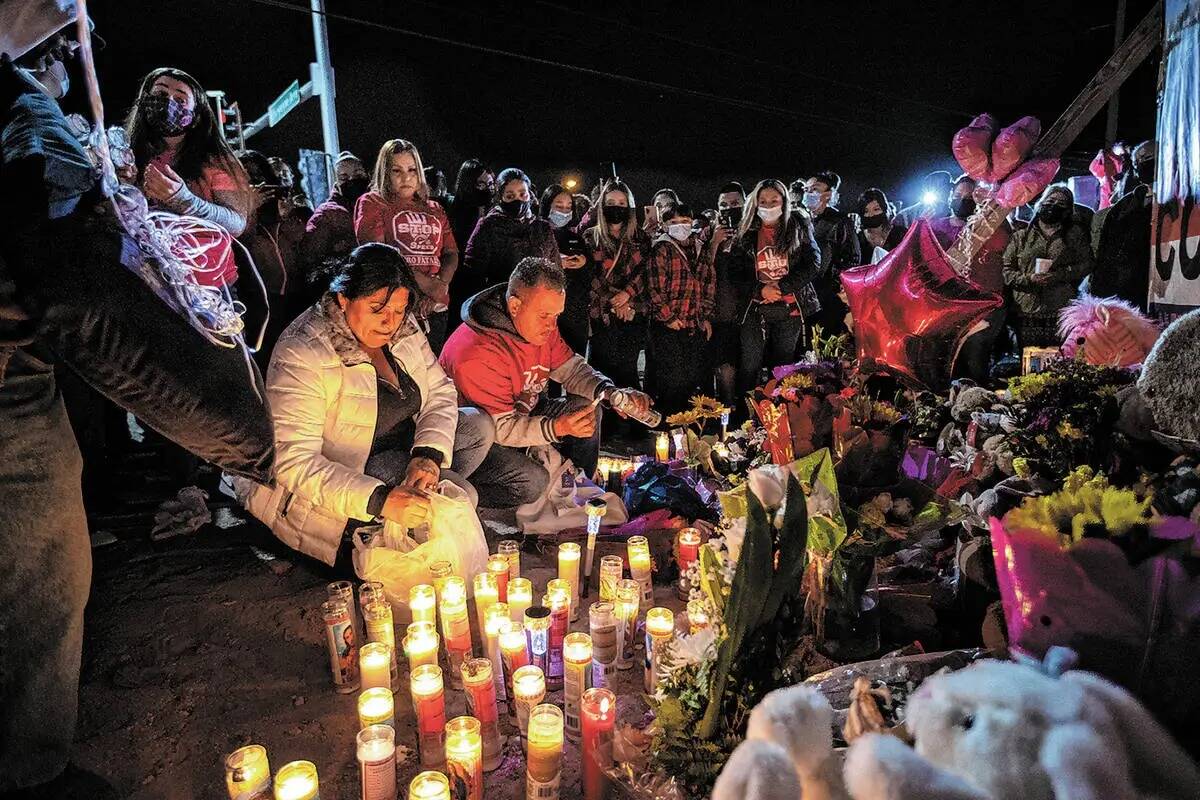 Erlinda Zacarias, izquierda, y su esposo Jesus Mejia-Santana, encienden velas durante una vigil ...