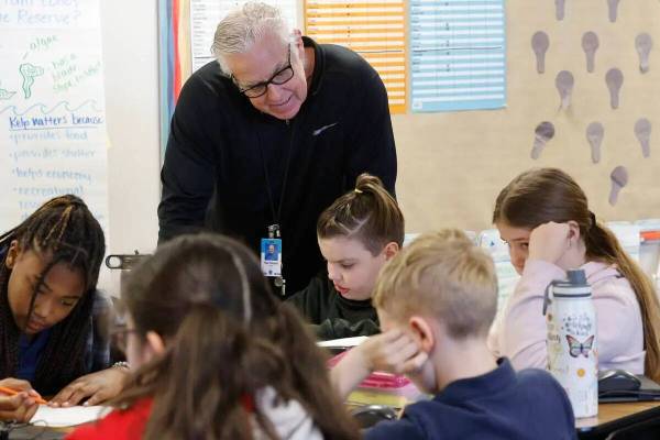Ray Finucan, special education teaching assistant, helps children during a fifth grade class at ...