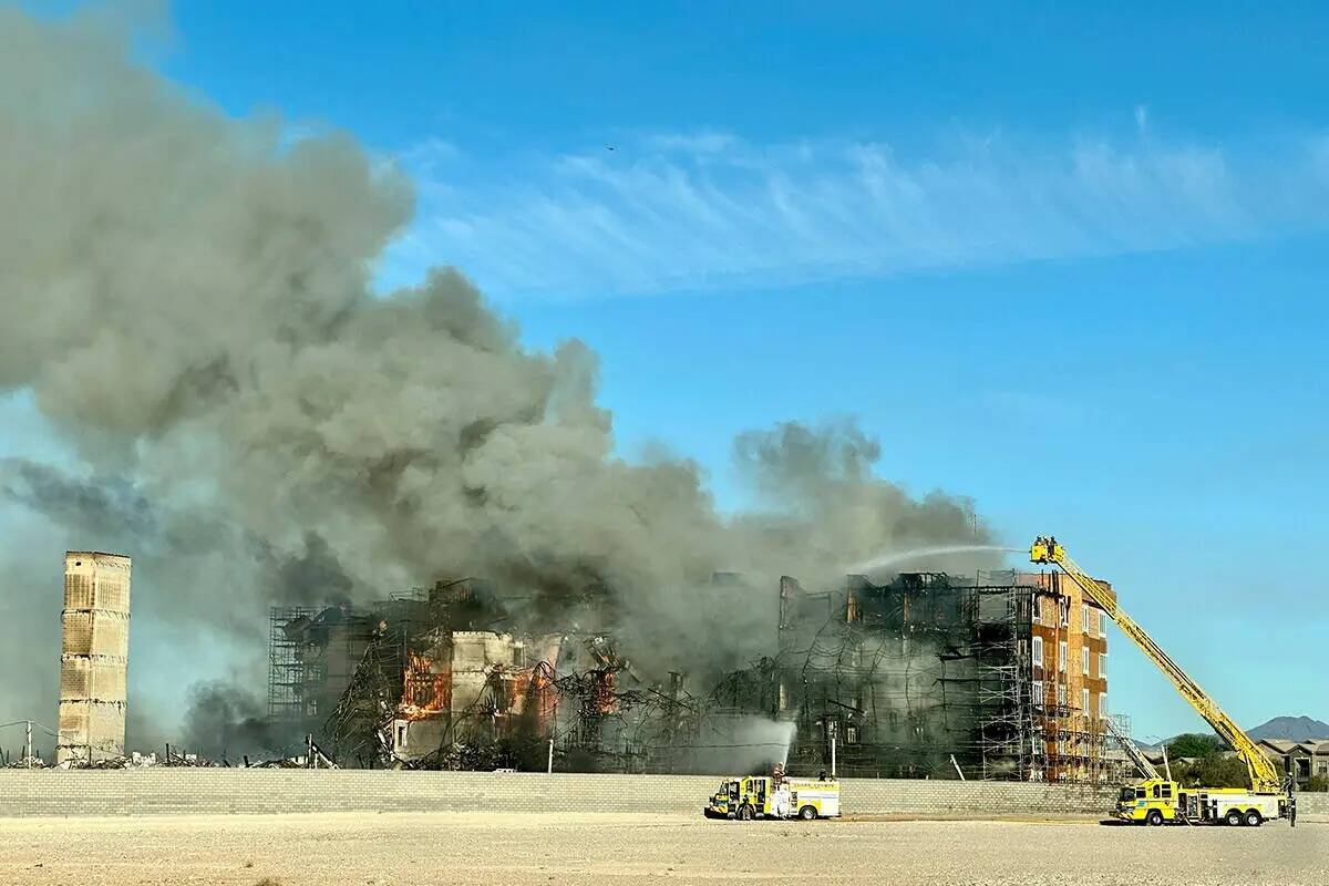 Los bomberos trabajan para extinguir un incendio en un complejo residencial en construcción ce ...