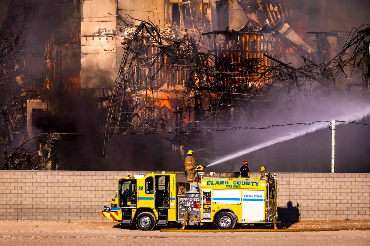 Los bomberos trabajan para extinguir un incendio en un complejo residencial en construcción ce ...