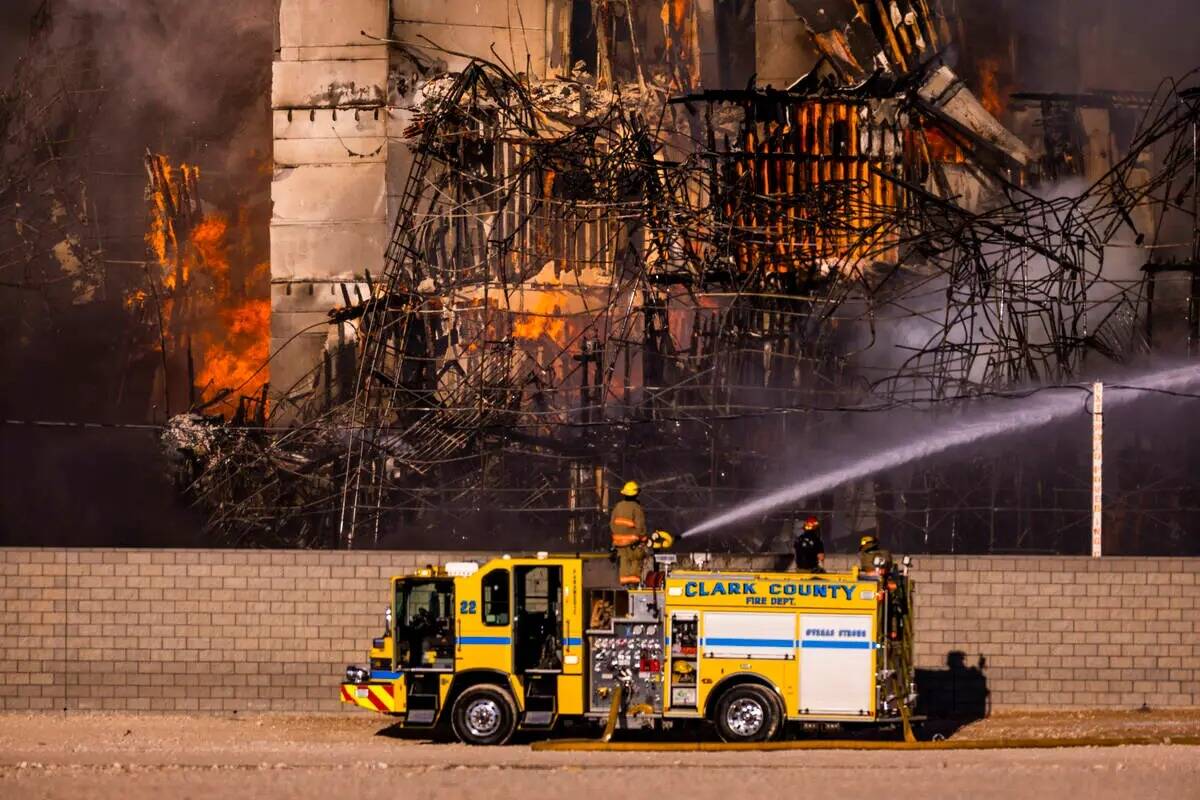 Los bomberos trabajan para extinguir un incendio en un complejo residencial en construcción ce ...