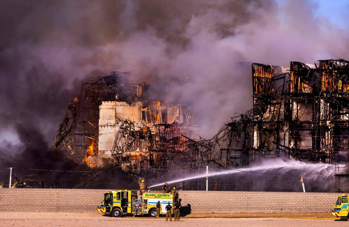 Los bomberos trabajan para extinguir un incendio en un complejo residencial en construcción ce ...