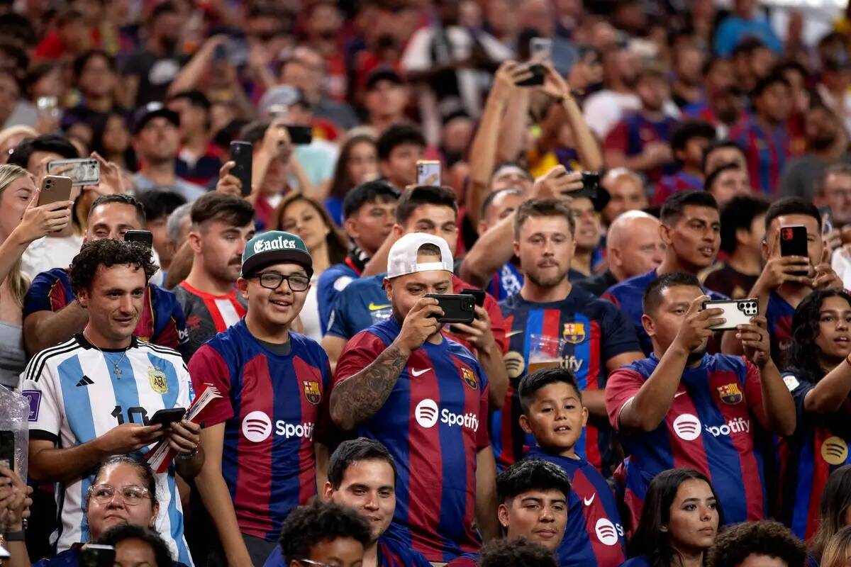Aficionados del Barcelona graban y observan un saque de esquina de su equipo durante la segunda ...