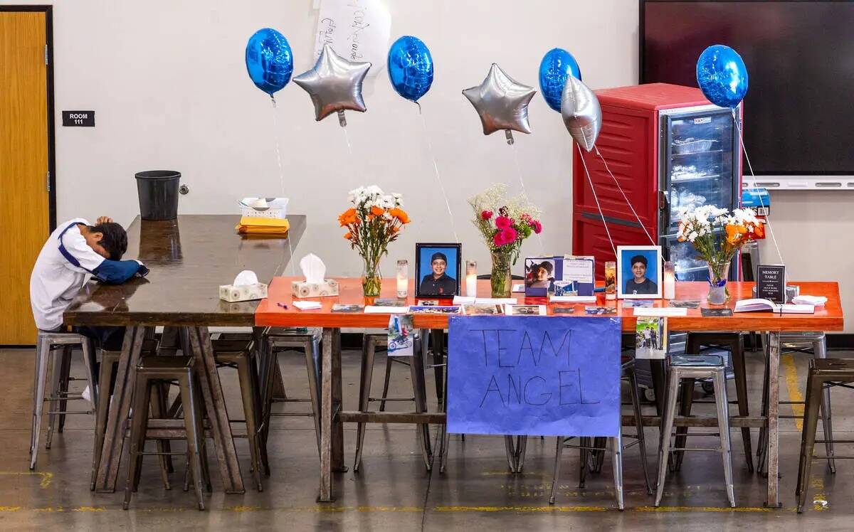 Un doliente apoya la cabeza sobre una mesa conmemorativa con artículos de Ángel Naranjo duran ...