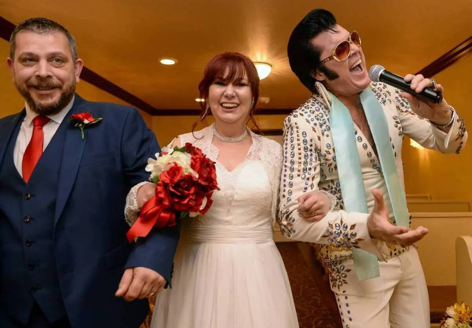 Ireland's Hugo and Sally Knights walk down the aisle with Elvis Presley impersonator Brendan...