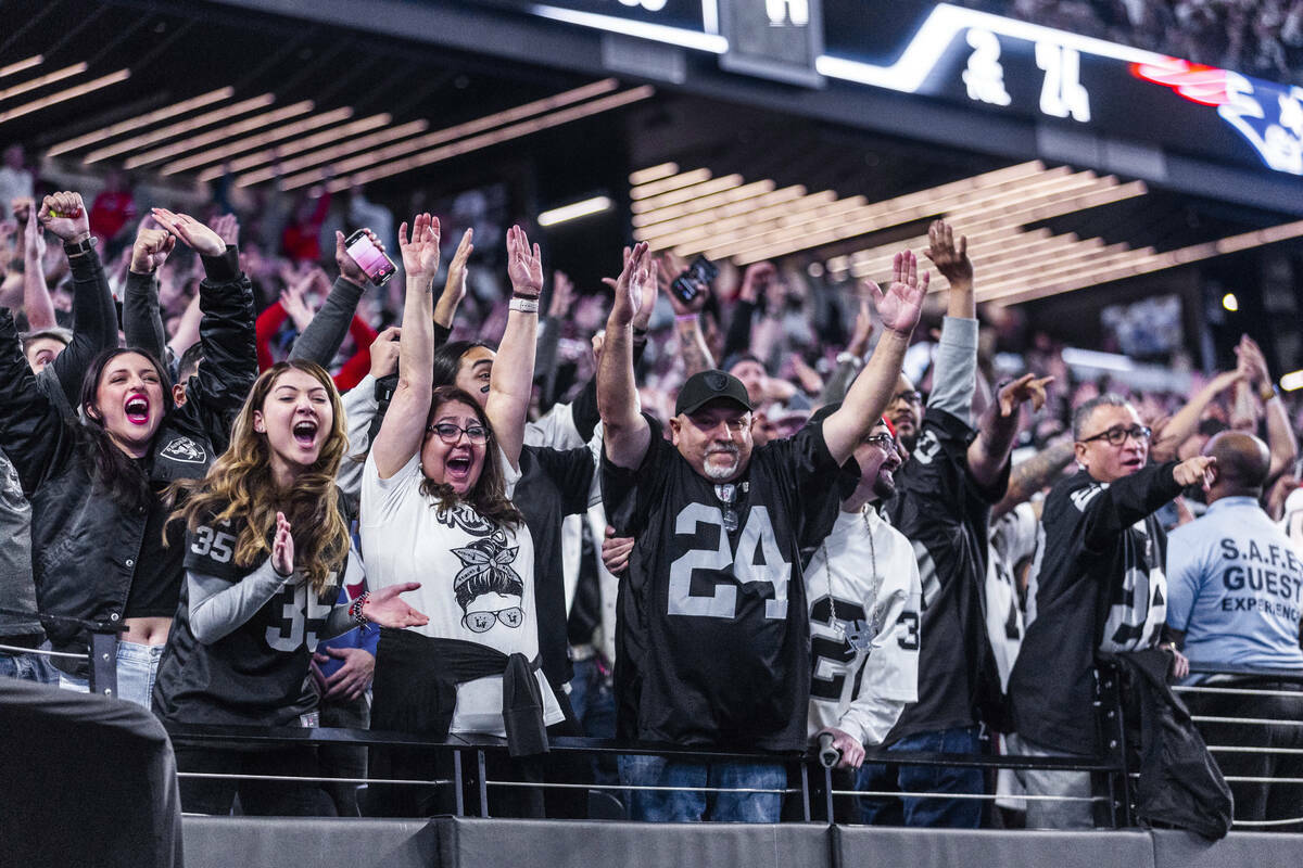 Aficionados de los Raiders celebran después de una anotación al final del partido contra los ...