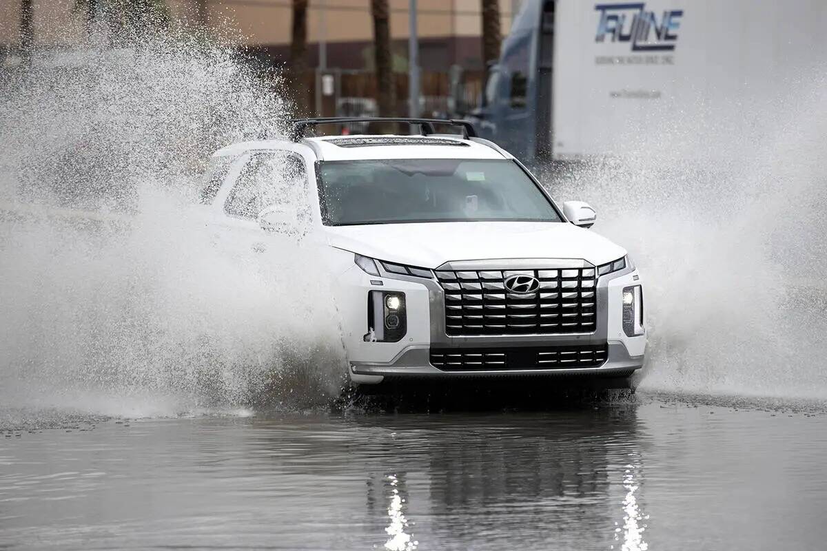 El tránsito navega por las aguas de inundación en West Sunset Road y South Decatur Boulevard ...