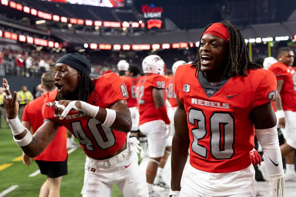 El defensa de la UNLV Daego Albert (40) y el defensa Trenton Holloway (20) celebran su victoria ...