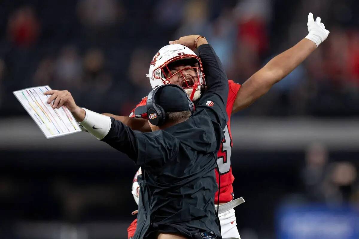 El coordinador defensivo de UNLV Mike Scherer celebra con el linebacker Blesyng Alualu-Tuiolemo ...