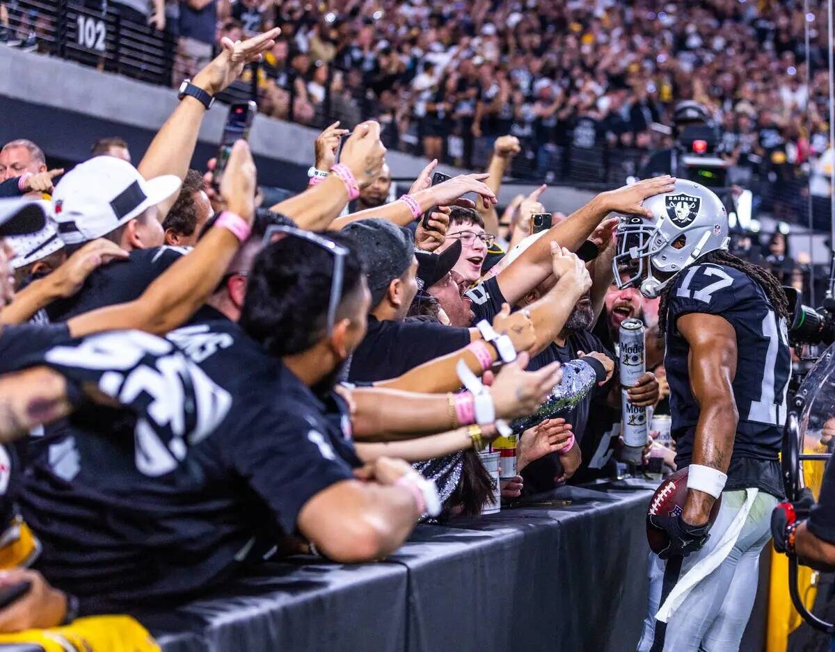 El wide receiver de los Raiders Davante Adams (17) celebra su touchdown con los fans durante la ...