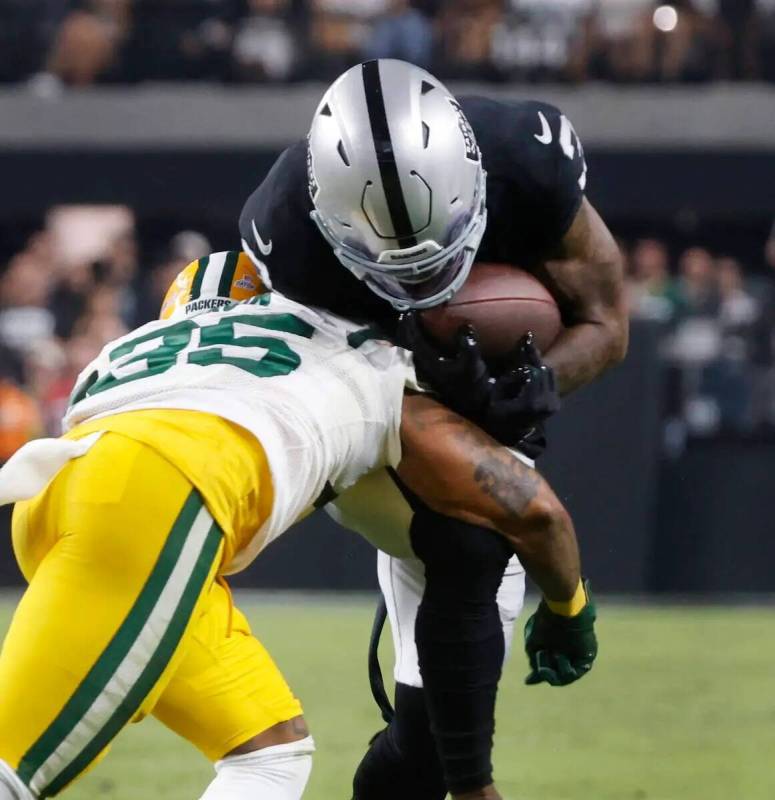 El wide receiver de los Raiders DeAndre Carter (3) es tacleado por el cornerback de los Green B ...